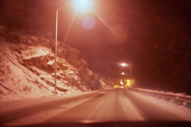 2009 snowy road with street lamp overhead.