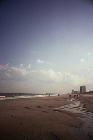 east coast with buildings on right by inland water.