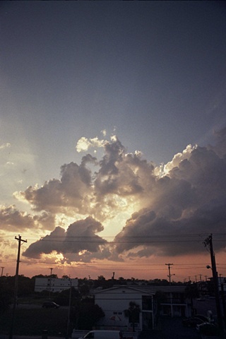 east coast sunset behind clouds with rays van bottom left. 