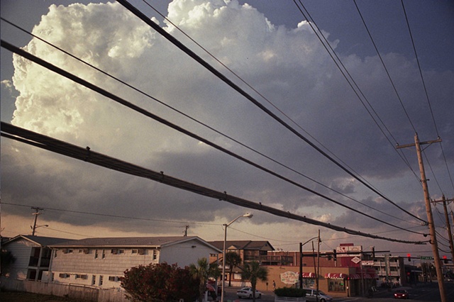 east coast powerlines with cumulonimbus and street. 