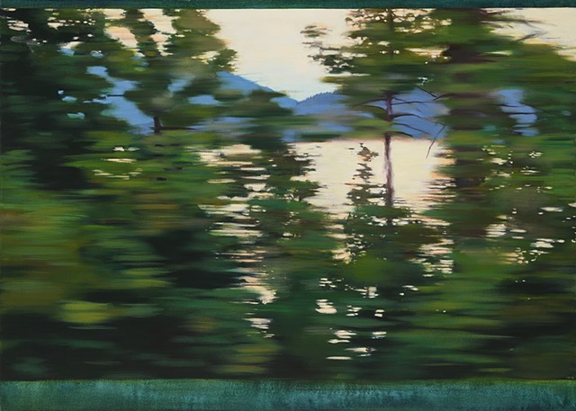 Driving by a sunset along a mountain lake