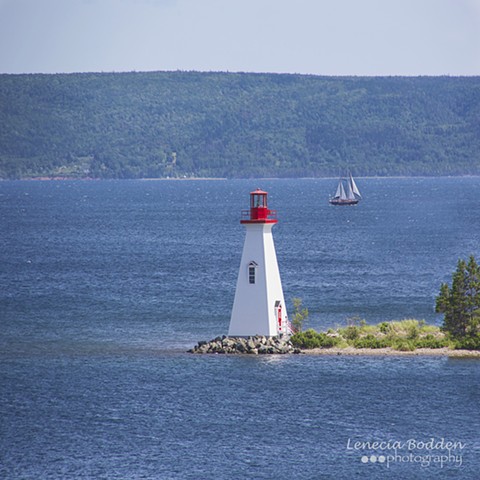 Lighthouse and sailboat