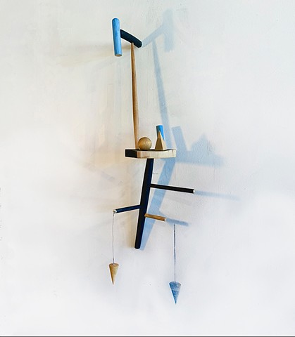 A wall sculpture with a found wood chair and wall drawing of cast shadows.