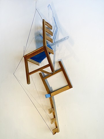 This is a sculpture made from a reconfigured found chair and wall drawing by Sheila Ghidini.