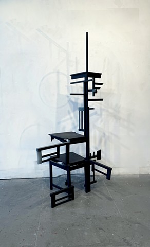 This is a sculpture constructed of reconfigured chairs and painted.