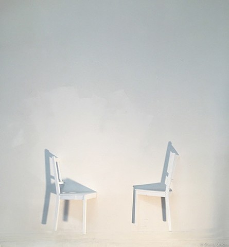 Reconfigured found chairs secured to the gallery wall by Sheila Ghidini.
