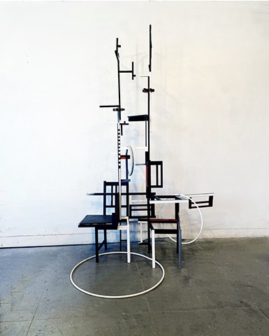 This is a sculpture created with reconfigured chairs, house paint and pvc thin pipes.