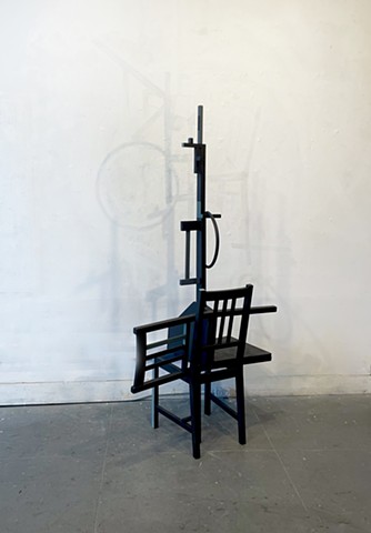 This is a sculpture comprised of reconfigured chairs and painted.