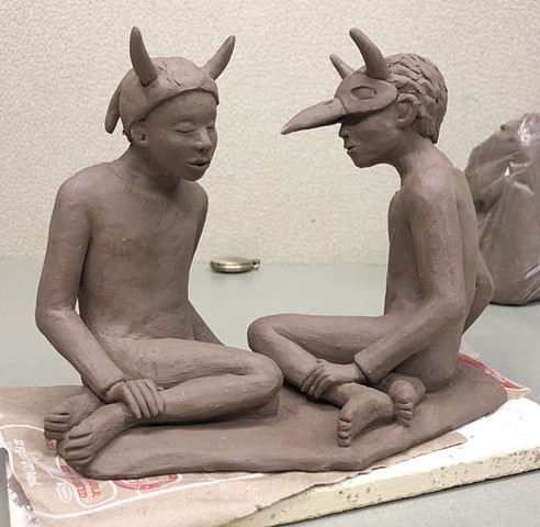 Building clay figures.