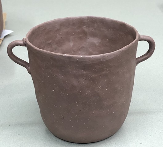 A hand built pot in cone 6 red clay. 