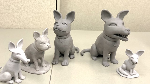 Working on little ceramic dog figures.