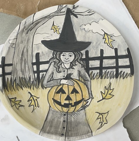 Drawing Halloween imagery on a greenware porcelain bowl.