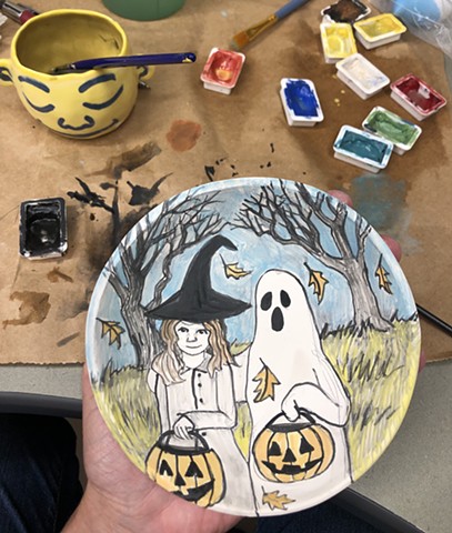 Halloween drawings being applied to porcelain greenware bowl.