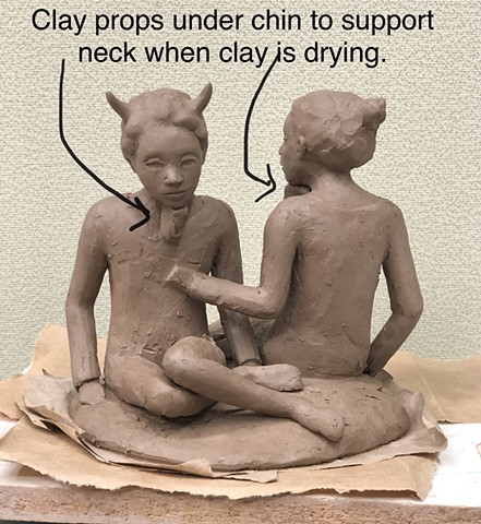 Building clay figures.
