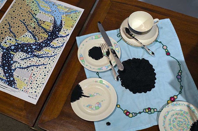 RIVER CAMPAIGN: Detail of hand-painted china, hand-painted flatware and hand-embroidered napkin
