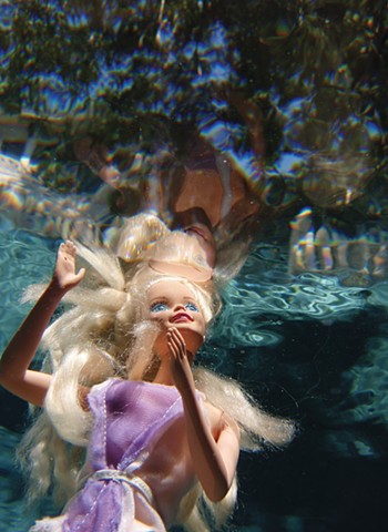 Photograph of Barbie Doll and her reflection by Daena Title