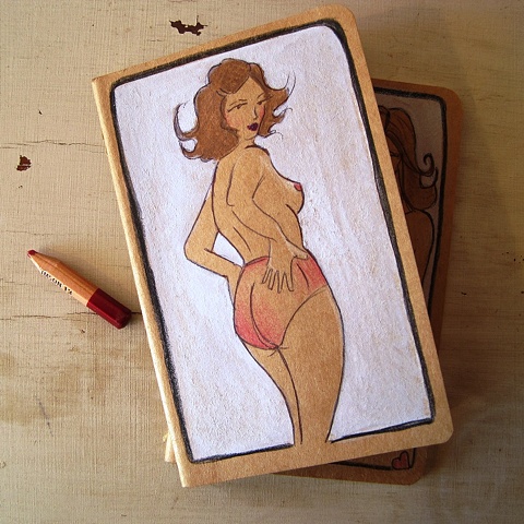Hand altered Moleskine notebook, by Brighton artist Linda Boucher. The cover of this journal is illustrated with a fierce looking woman, in sheer pink panties. Drawn with ink, aquarelle pencils and gouache- this is a truly unique piece of artwork.