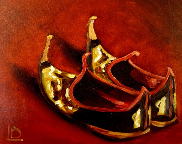 oil painting of gorgeous gold, black and red turkish slippers with turned up toes, by Brighton artist Linda Boucher