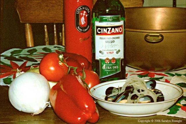 Mussels with wine bottles and red vegetables