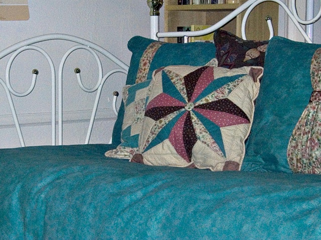 Detail showing cushions and duvet