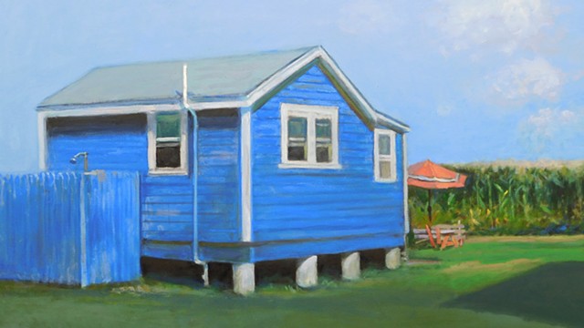 Blue cottage at cornfield