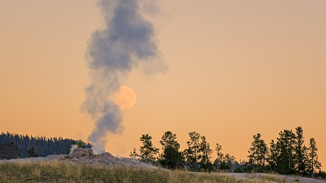 Old Faithful Steaming over the Full Moon