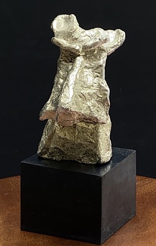 Abstract expressionist scottie dog in pewter with gold tone on gray polished cement base.