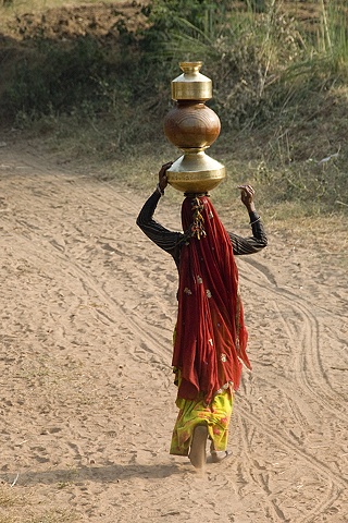 Woman Carrying Pots