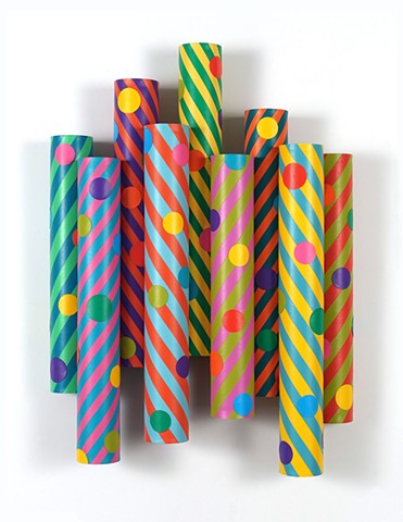 Wall sculpture with colorful striped cylinders and polkadots