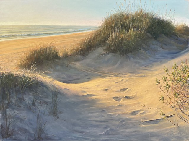 A warm autumn sunrise illuminating this dune in the Outer Banks