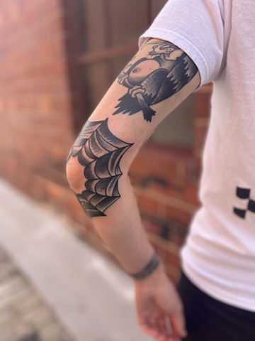 Spider web elbow tattoo black and grey