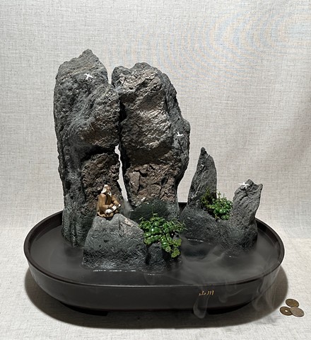 Tabletop feather rock fountain with miniature ceramic musician figure and birds, plants, waterfall, and mist