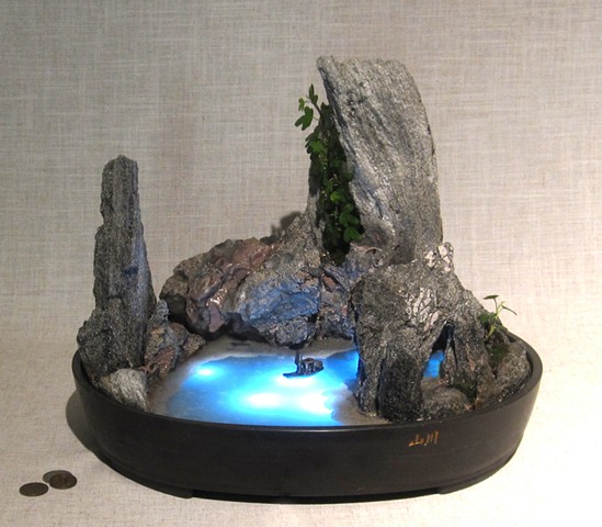 illuminated fountain with feather rock and ivy