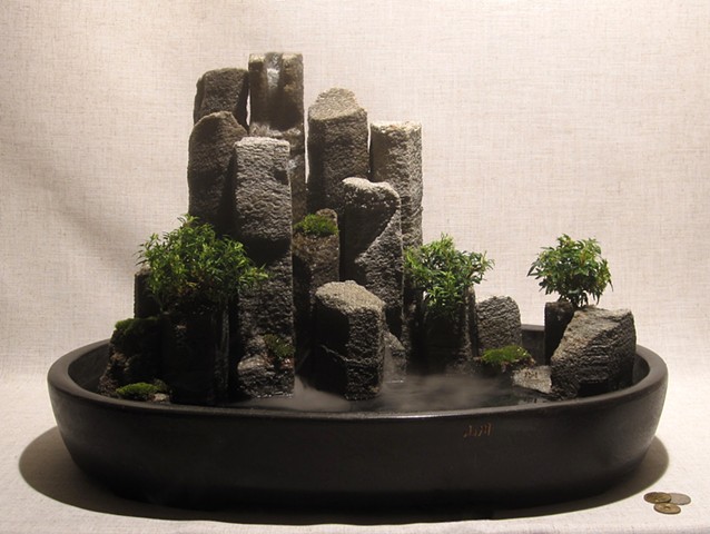 miniature basalt columnnar iceland waterfall with plants and miniature puffins