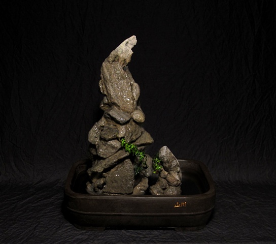 feather rock cairns in animal totem shapes with ivy 