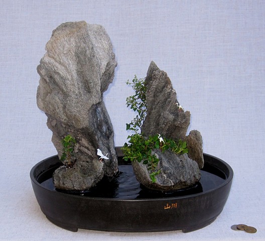 Asian feather rock fountain with miniature cranes