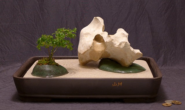 tabletop fountain with eroded limestone, aralia