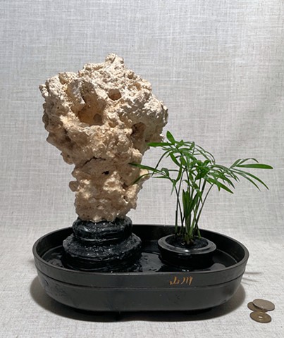 waterfall inside South Seas base rock with miniature palm in separate planter