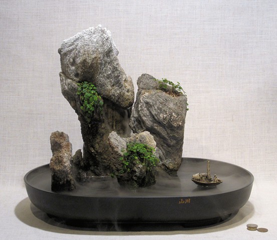 miniature mountain islands with fogger, waterfall, and boat
