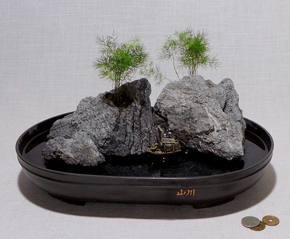 feather rock fountain with live plants, waterfall, and miniature figurines