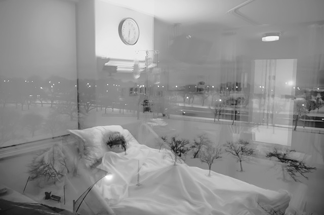 double exposure of a woman in a hospital bed super imposed on the the view from the indown of a park and it looks like sh's making a transition photographed by Lucy Mueller Photogrpahy