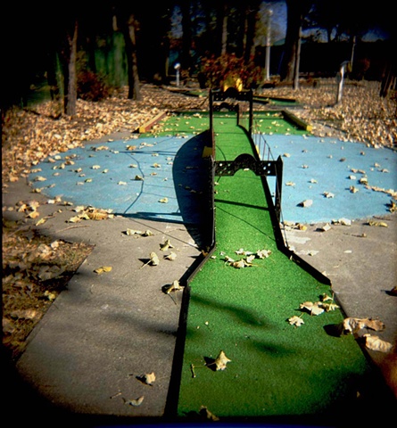 A miniature green bridge on a miniature golf course in Diversey harbor at the Chicago Park District photgraphed by Lucy Mueller