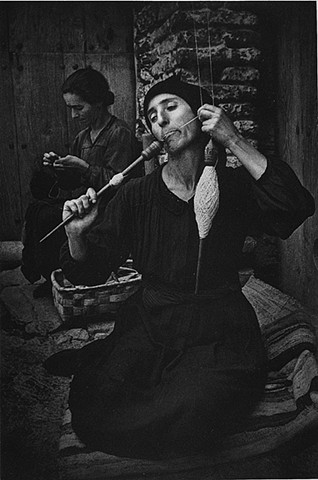 "The Spinner" photo by Eugene Smith of woman spinning wool from Spanish Village series published by LIFE Magazine