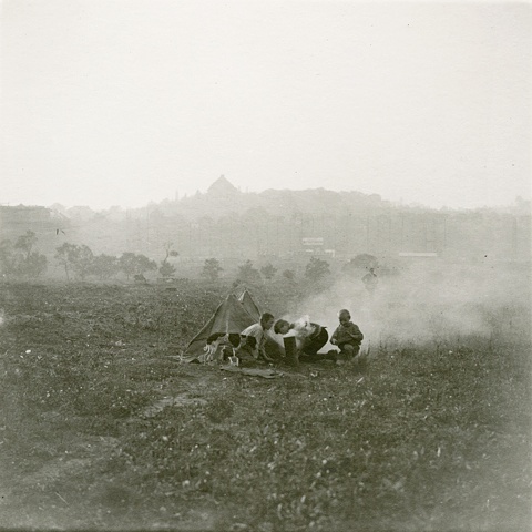 Untitled (three boys camping in a field)