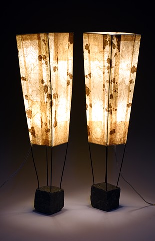 stone bases painted steel structures hand decorated paper shades brown beige warm light