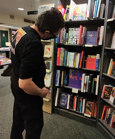 David Looking at Art Books in Bookshop