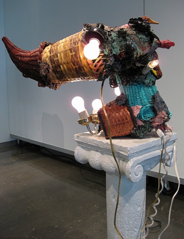 Title/Materials: Wicker Baskets and Cornucopia, Light Fixtures, Light Bulbs, Electrical Receptacles, Electrical Wiring, Plaster Column, Paint, Sawdust. Wood Glue, Extension Cord