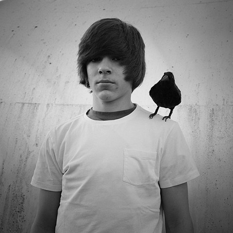 Boy with black bird.