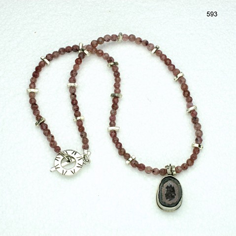 bezel set geode pendant on a strand of faceted pink muscovite, with silver accent beads and a silver toggle (#593)