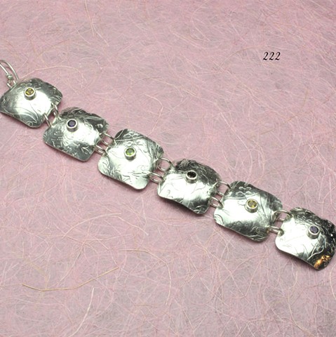 floral embossed silver square links bracelet embellished with bezel set faceted amethyst, citrine, garnet and peridot gems, hook clasp, 
7 1/2" (#222)